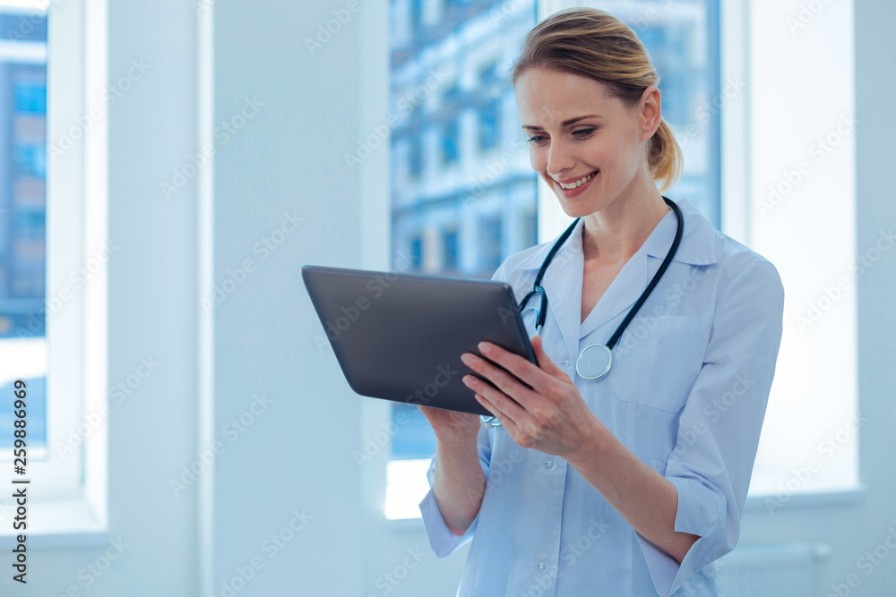 Amazing woman looking at screen of tablet Amazing woman looking at screen of tablet