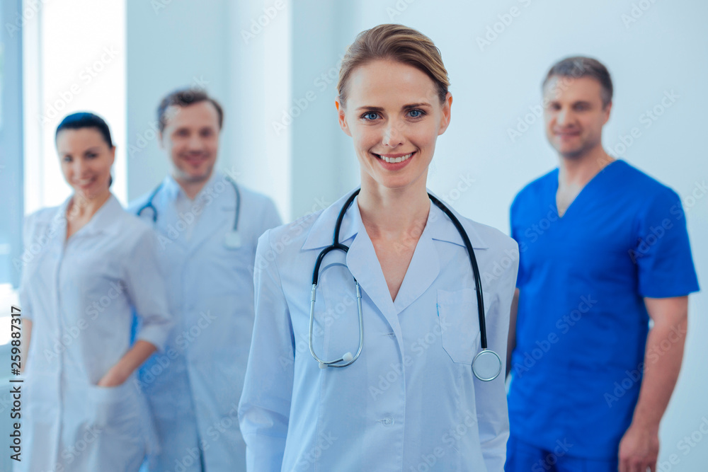 Positive delighted doctor posing on camera Positive delighted doctor posing on camera