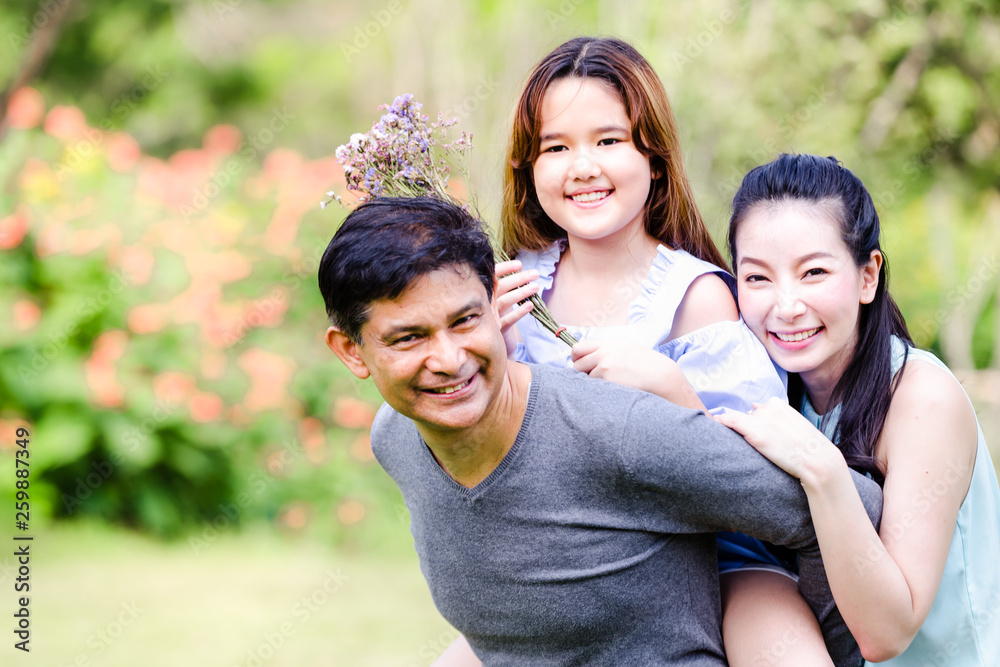 Cheerful family having picnic relaxing together on green nature in park Cheerful family having picnic relaxing together on green nature in park