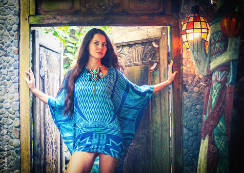 Fashion portrait of beautiful hippie young woman wearing boho chic clothes, summer, outdoors. Soft warm vintage color tone instagram filters. Artsy bohemian style, hippy vibes