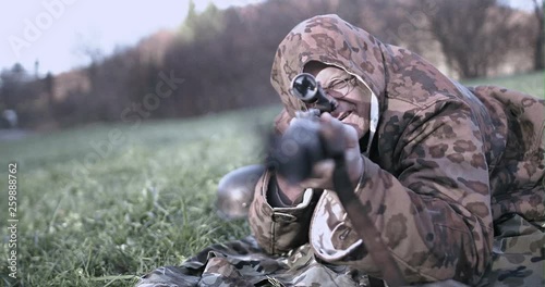 WWII - German sniper lies in meadow photo
