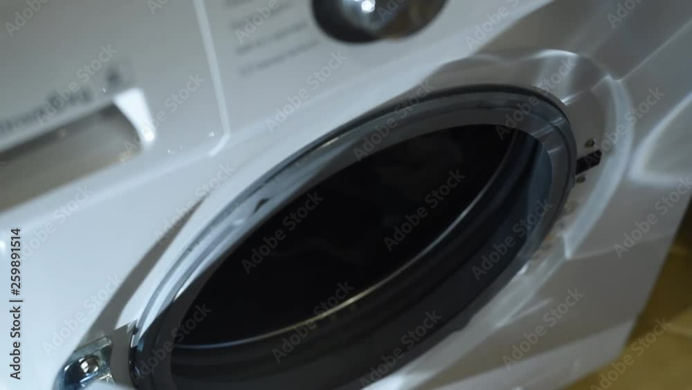 Loading clothes to washer machine. Preparing laundry washing