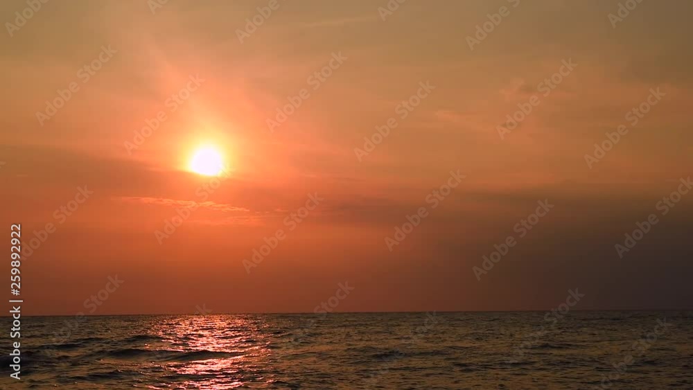 Amazing sunset over the tropical beach. ocean beach waves on beach at sunset time , sunlight reflect on water surface. beautiful evening nature sea background. Amazing sunset over the tropical beach. ocean beach waves on beach at sunset time , sunlight reflect on water surface. beautiful evening nature sea background.