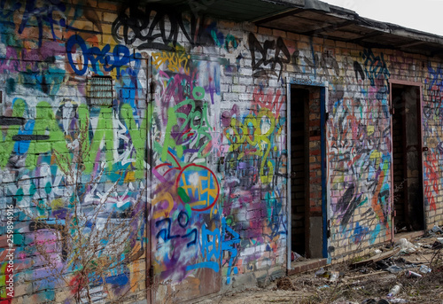 Destroyed brick buildings painted with graffiti. Russian favella. Moscow region.