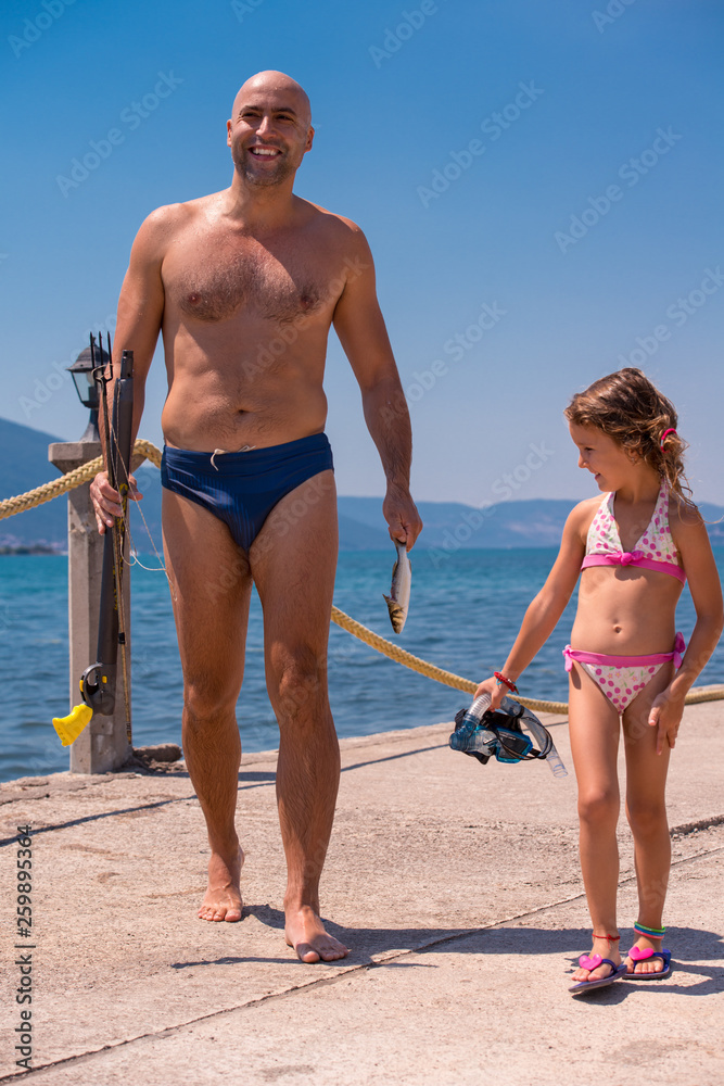 fisherman his little daughter after underwater fishing