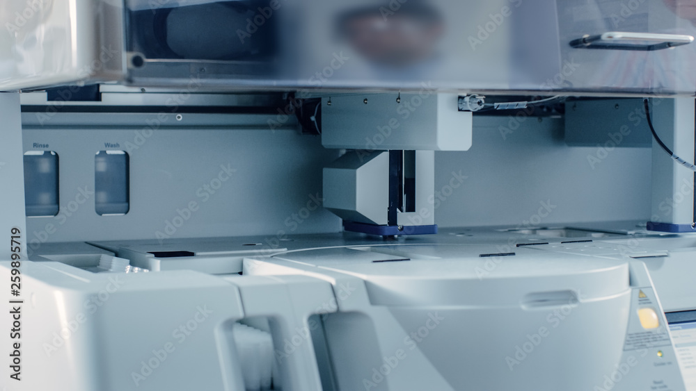 Close-up Shot of Automated Medical Equipmemt Working. Test Tube, Blood and Genetic Material Analyzing Machine. Moving and Tacking Samples. Close-up Shot of Automated Medical Equipmemt Working. Test Tube, Blood and Genetic Material Analyzing Machine. Moving and Tacking Samples.