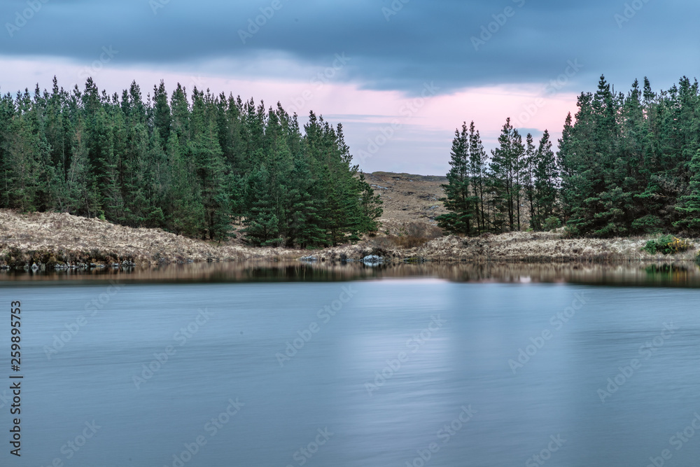 Sunset in Conemara lake with Pine Forest around