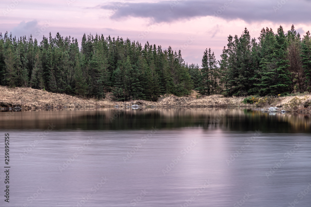Sunset in Conemara lake with Pine Forest around Sunset in Conemara lake with Pine Forest around
