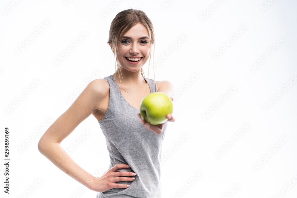 Female fitness model holding apple. Healthy eat and sport concept. Female fitness model holding apple. Healthy eat and sport concept.