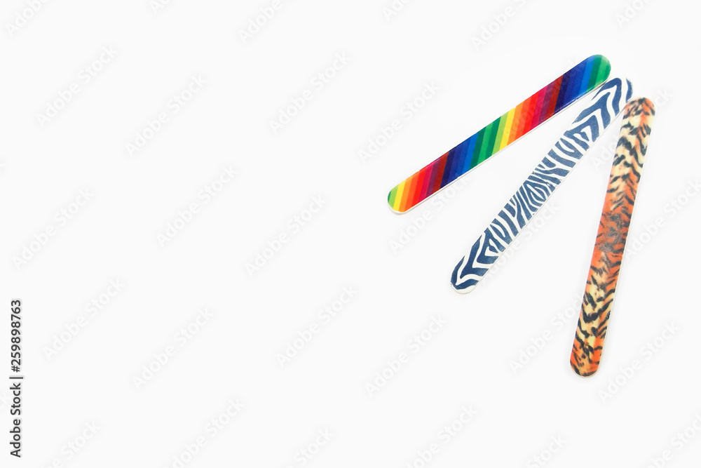 Obraz premium Multicolored used pedicure manicure nail files on white isolated background