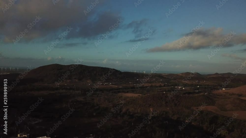 AERIAL: panning over some housing towards the coast of Coamo, Puerto Rico during a precious sunrise. AERIAL: panning over some housing towards the coast of Coamo, Puerto Rico during a precious sunrise.
