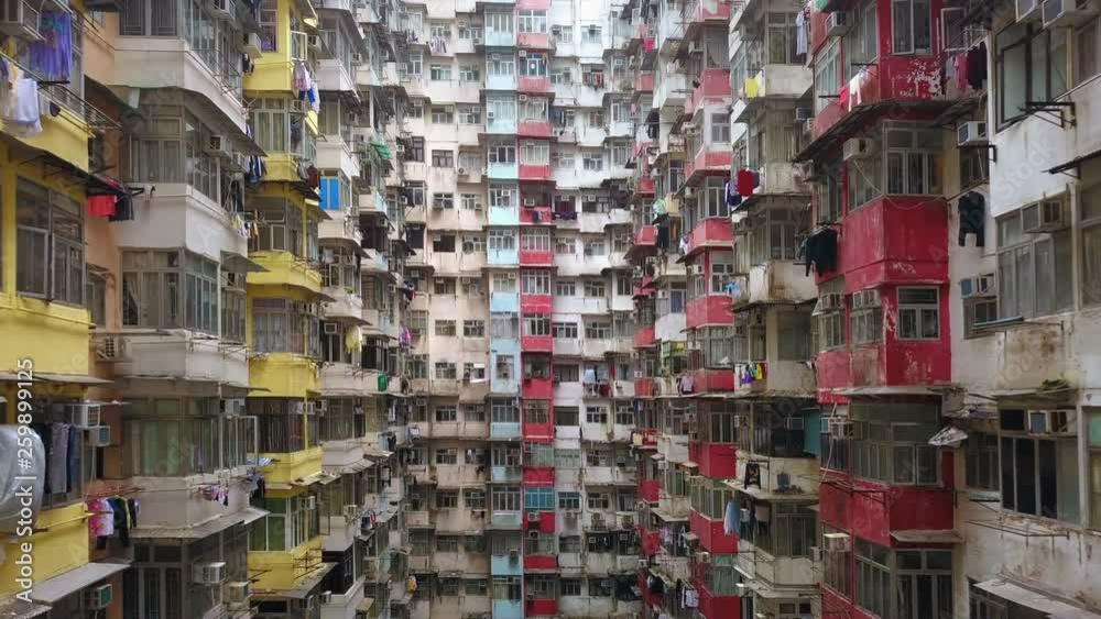 Aerial view of Yick Fat Building, Quarry Bay, Hong Kong. Residential area in old apartment with windows. High-rise building, skyscraper with windows of architecture in urban city.