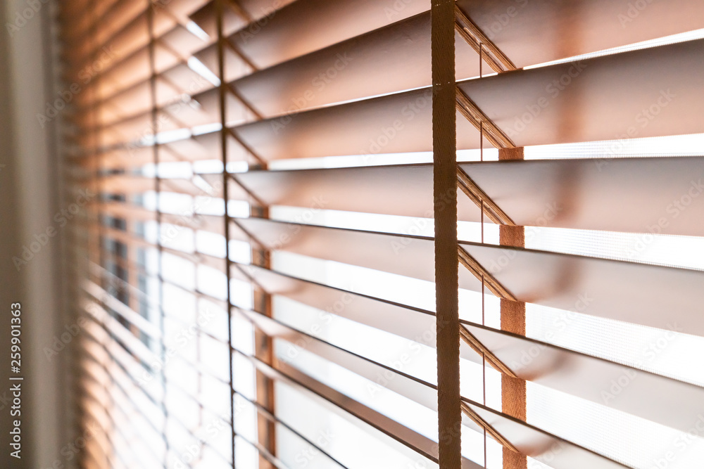 Wooden shutters on the window in the living room Wooden shutters on the window in the living room