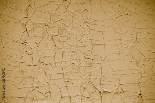 Vintage cracked flaky yellow paint background. Abstract yellow peeling paint, abstract. Pattern of сrack yellow wall texture.