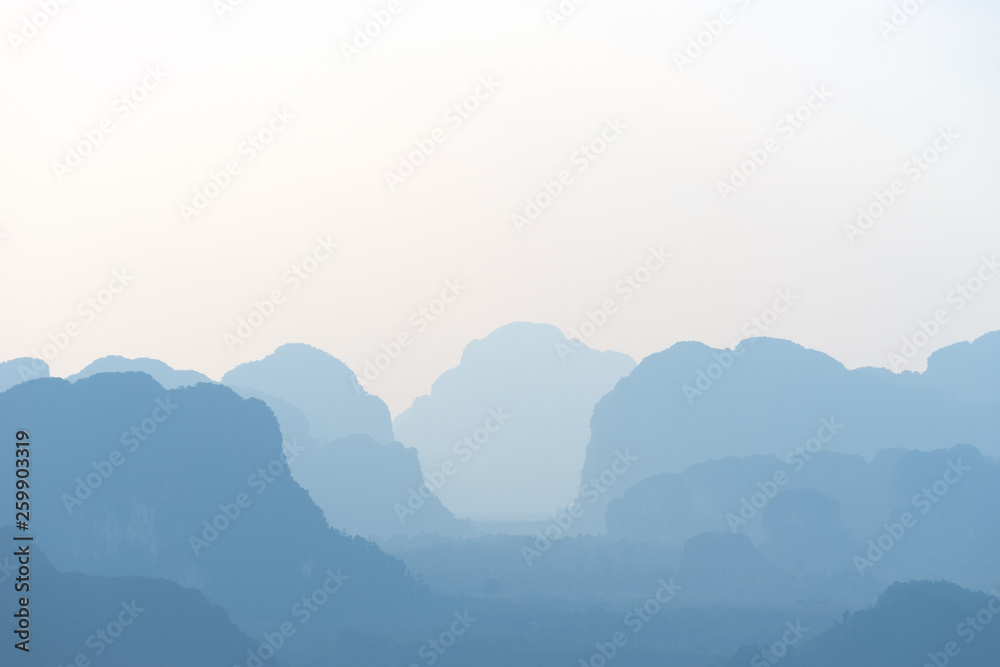 Landscape of blue silhouettes of mountains and hills in tonal perspective of in asian valley