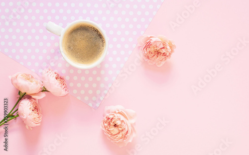Composition of white cup with black coffee and flowers on a light pink background. Morning concept. Flat Lay. Top View