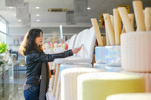 Woman buying furnitures in shop, selecting products photo