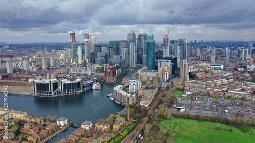 Aerial drone shot from iconic Canary Wharf skyscraper business and financial area with lots of clouds  Docklands  Isle of Dogs  London  United Kingdom