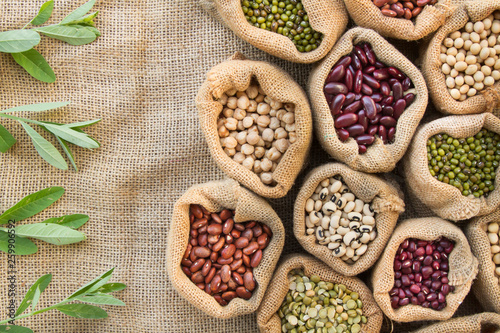 Legumes seed in bag with leaf of bean background, top view