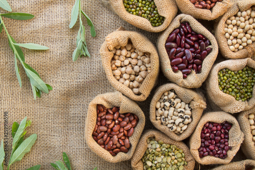 Bean and Nut seed in the bag with leaf background, top view. Dried seed and cereal plant concept.