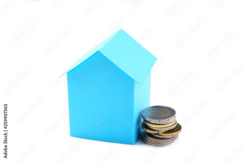 Blue paper house with coins isolated on white background Blue paper house with coins isolated on white background