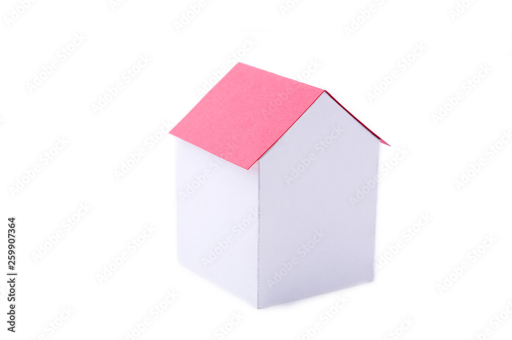 A paper house with red roof on a white background. A paper house with red roof on a white background.