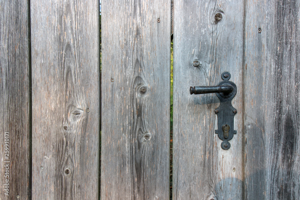 The Modern wooden door with metal door handle over the white wall. -Image The Modern wooden door with metal door handle over the white wall. -Image