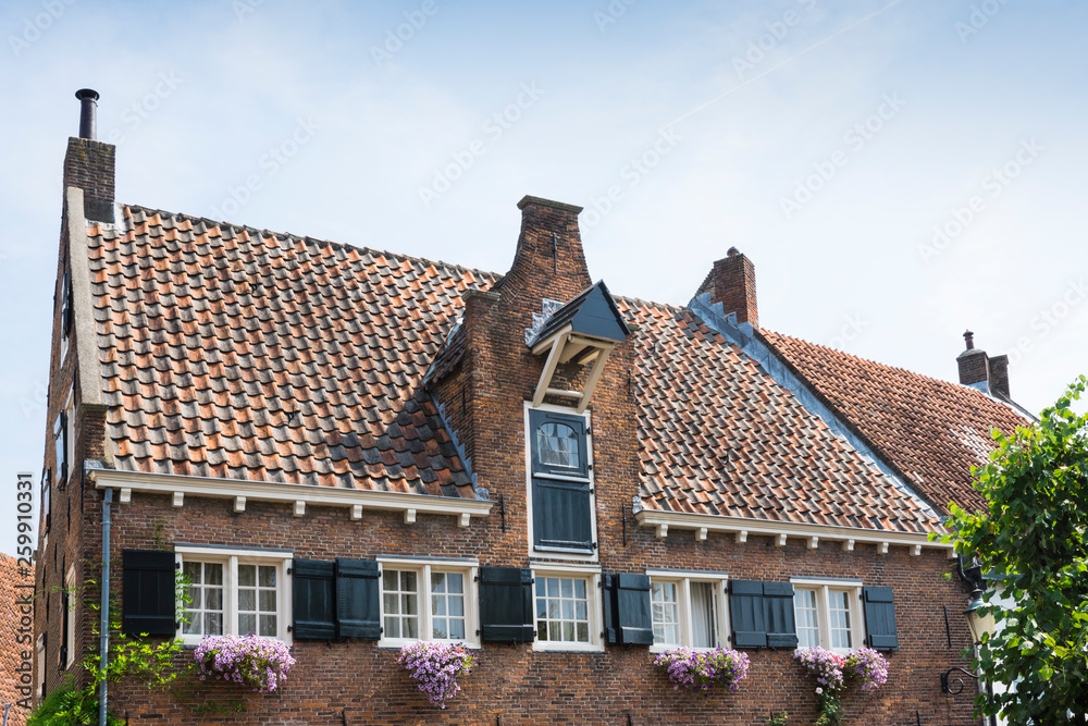house with shutters, flowers and Dutch door in Nieuweweg in Amersfoort, The Netherlands