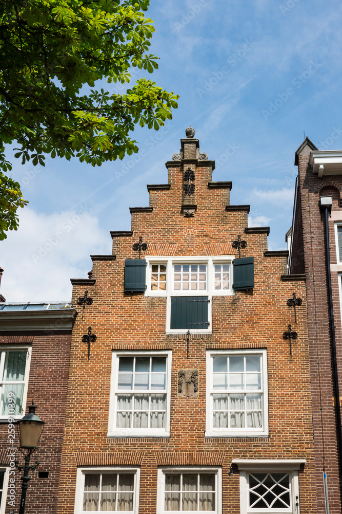 typical Dutch stepped gable house with shutters in Amersfoort, The Netherlands
