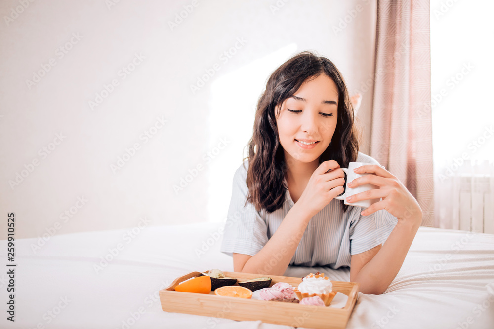 Young woman eating healthy breakfast in bed Young woman eating healthy breakfast in bed