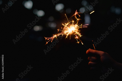 Woman hand holding a burning sparkler
