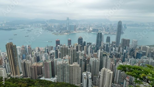 HONG KONG, CHINA - APRIL 2, 2019: 4K Cinematic Zooming Out Time Lapse Footage of Victoria Harbour taken from The Peak in Hong Kong during cloudy day.
