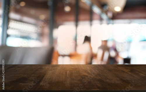 Empty dark wooden table in front of abstract blurred bokeh background of restaurant . can be used for display or montage your products.Mock up for space. © Charlie's