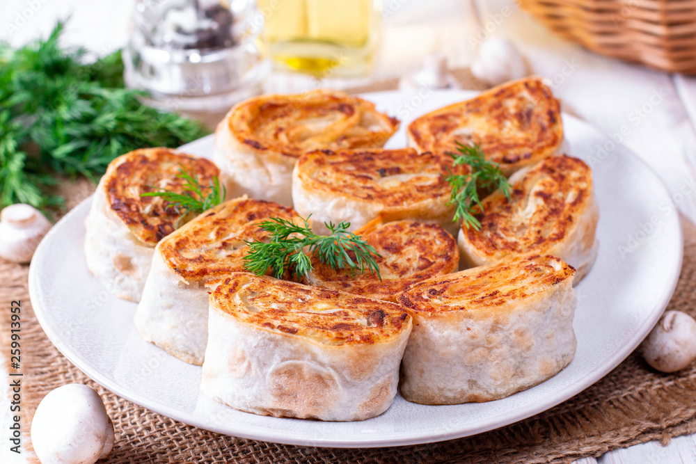 Fried lavash rolls with potatoes and mushrooms