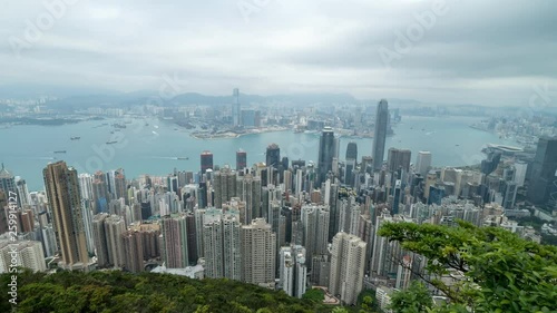 HONG KONG, CHINA - APRIL 2, 2019: 4K Cinematic Zooming In Fast Time Lapse Footage of Victoria Harbour taken from The Peak in Hong Kong during cloudy day.