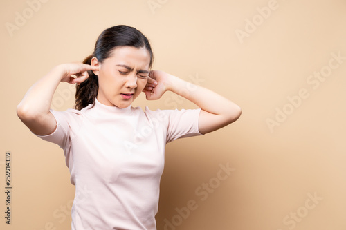 Woman putting a finger into her ear