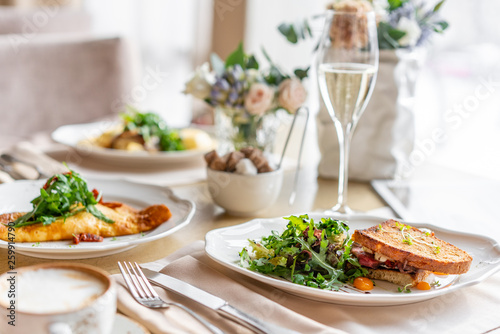 French toast brioche  Sandwich with pastrami and sun-dried tomatoes. Light morning Breakfast  fresh warm pastries on table in restaurant