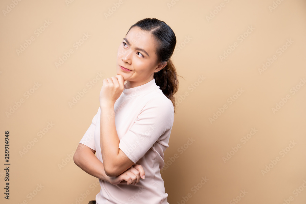 Angry woman standing isolated over beige brown background Angry woman standing isolated over beige brown background