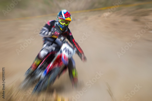 Blurry image of motorcycle rider during motocross race