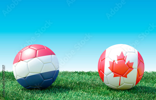 Two soccer balls in flags colors on green grass. Netherlands and Canada. 3d image