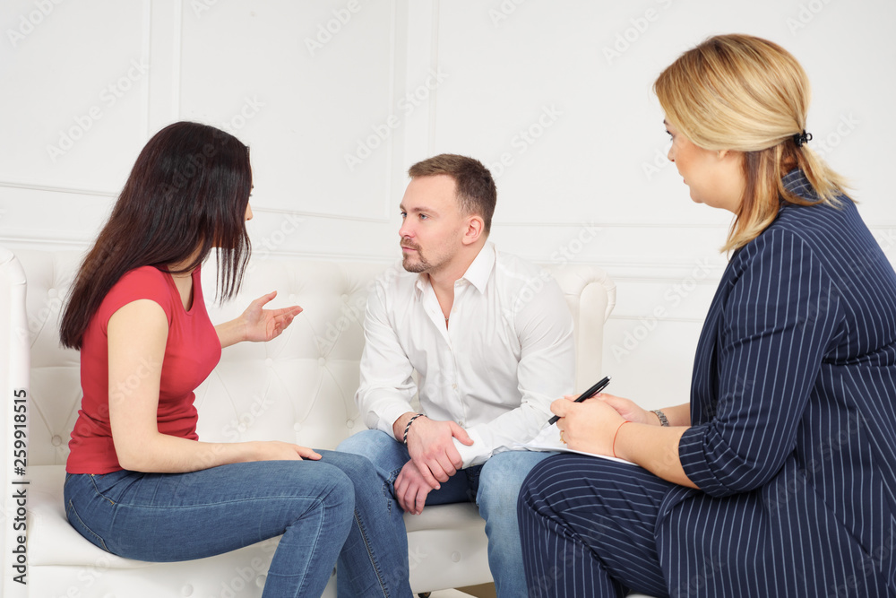 Couple counseling concept. disappointed in marriage wife complaining on husband sitting on couch