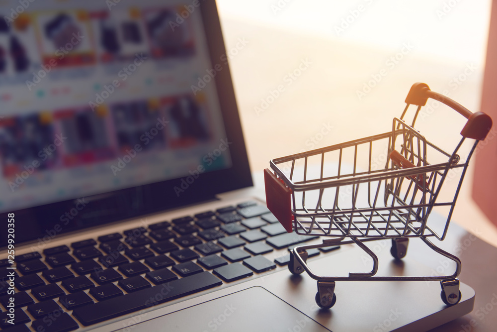 Shopping online concept - shopping cart or trolley on a laptop keyboard. Shopping service on The online web. with copy space