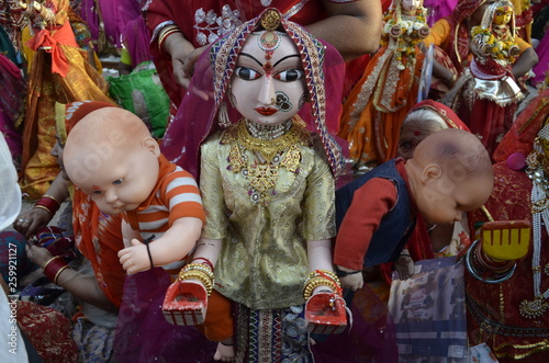 Gangaur gaur statue with red saree and ornaments with two babies on both hand