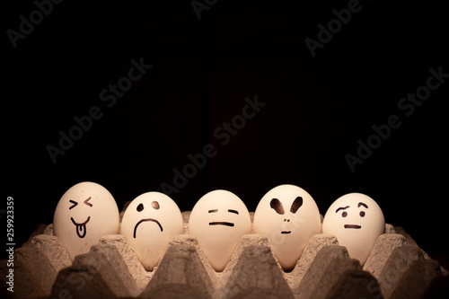 Five eggs with funny faces. Conceptual image.