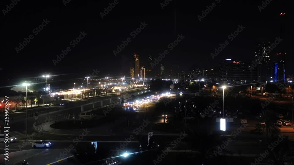 Beautiful time lapse view of Abu Dhabi city skyline and landmark towers from the corniche street at early morning, clouds and blue sky