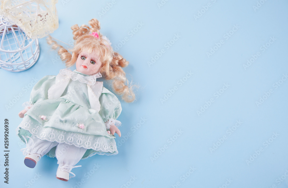 Cute vintage doll on the blue background