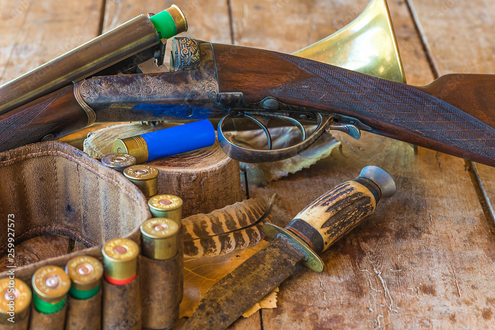 Beautiful hunting rifle and equipments on the old wooden background