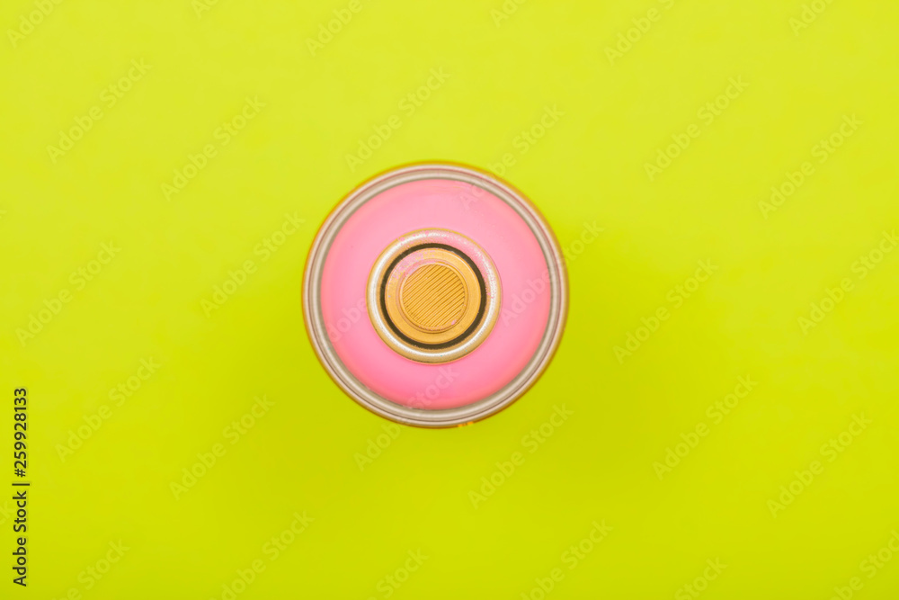 pink spray can on green background pink spray can on green background