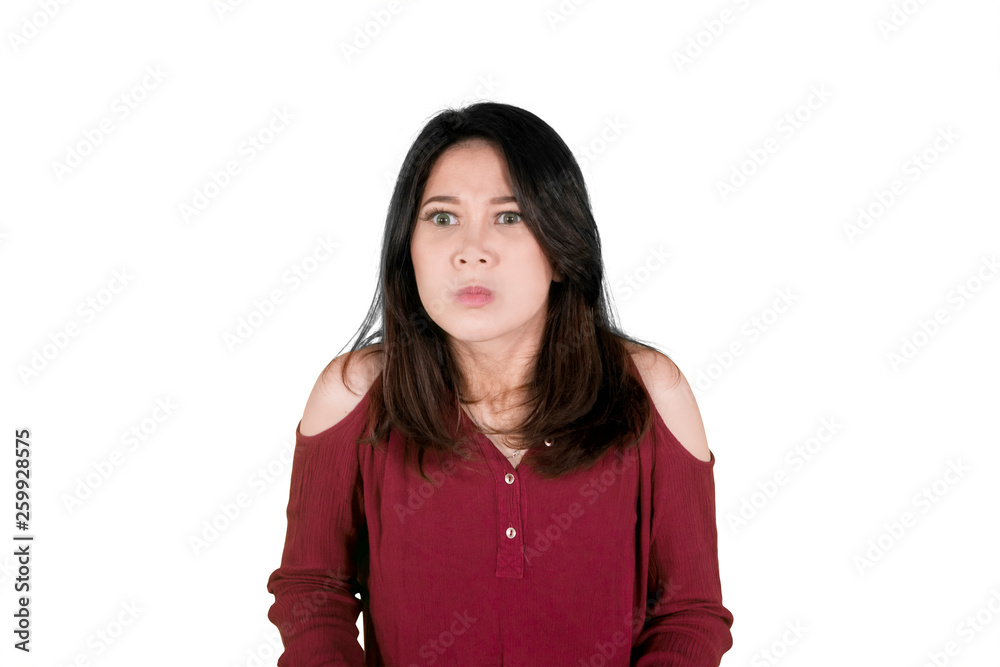 Young woman expresses annoyed face on studio Young woman expresses annoyed face on studio
