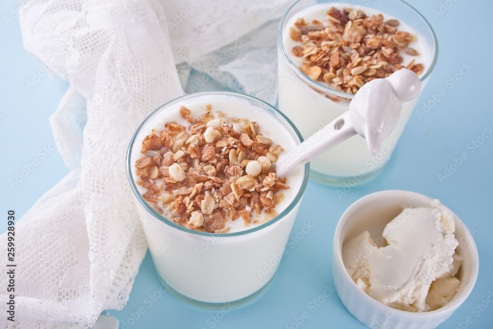 Yogurt in glass with muesli, cream cheese on a table with white napkin. Yogurt in glass with muesli, cream cheese on a table with white napkin.